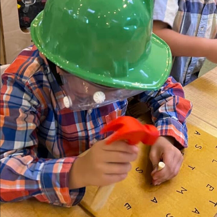 Boy playing with toy hammer