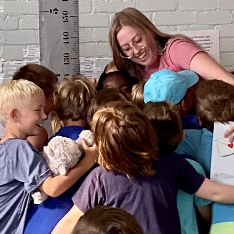 Students hug Ms. Annika.
