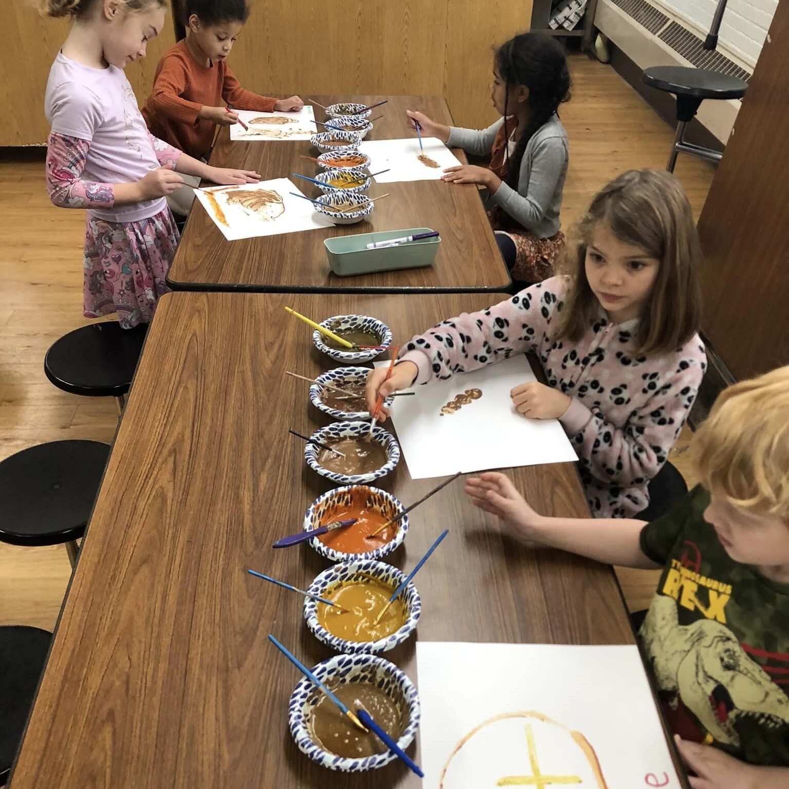 Discovery Care students paint using spices.