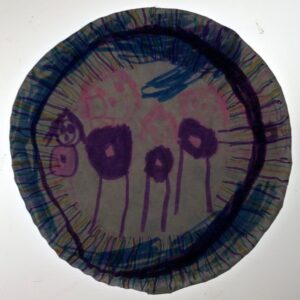 A drawing of a family on a paper plate.